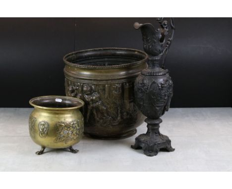 Brass Log Basket with embossed decoration of Putti playing in a Woodland, 35cm high together with a Brass Planter with emboss