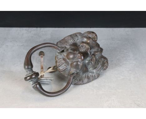 A vintage brass lion head door knocker with twin bolt fixing. 