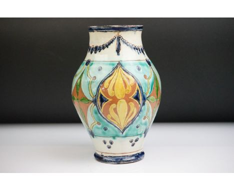 Della Robbia Pottery (Birkenhead 1894-1906) Baluster Vase with incised decoration in shades of green, blue, ochre and yellow,