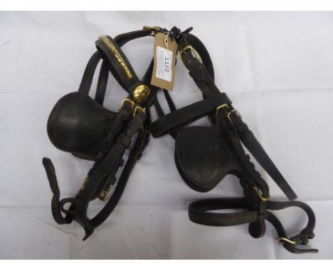 2 vintage brown leather driving pony bridles - 1 with decorative brass brow band and rosettes; in good condition&nbsp;&nbsp;