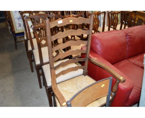An oak ladder back and rush seated elbow chair 