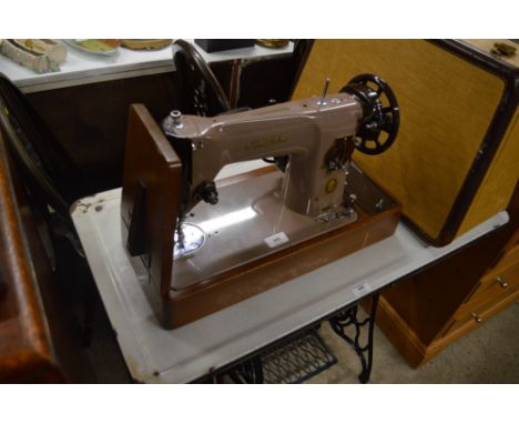 A Singer sewing machine with carrying case - sold as collector's item