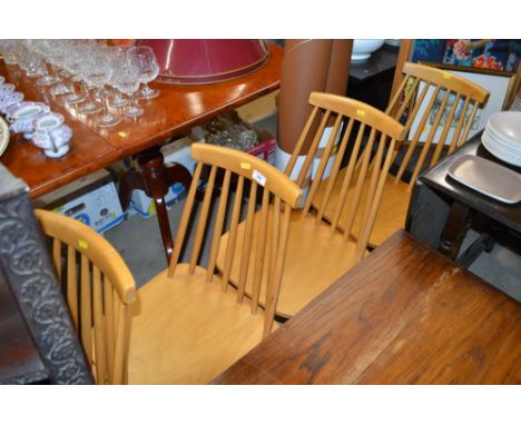 A set of four stick back kitchen chairs 