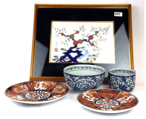 A framed Japanese hand painted porcelain panel, 48 x 38cm, with two Imari plates and two bowls.