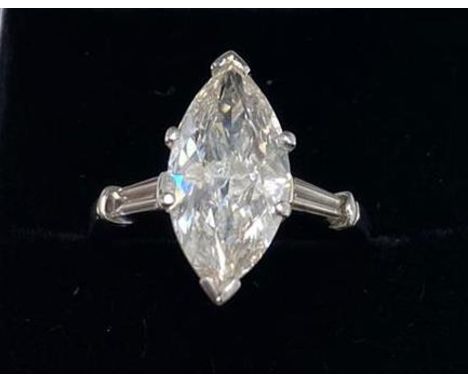 A platinum ring set with a 3ct marquise cut centre diamond with baguette cut diamond set shoulders, with EDR certificate, col