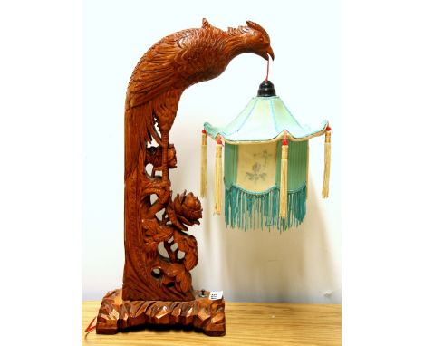 A carved wooden Chinese table lamp and pagoda shade, H. 48cm.