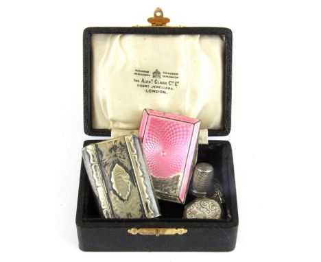 An enamelled hallmarked silver box with a silver plated snuff box, sterling silver thimble and a silver locket and chain.