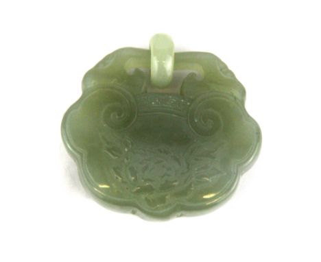 A Chinese carved jadeite jade lock amulet, W. 5cm.