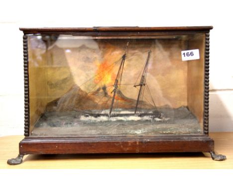 A mahogany cased musical automaton of a sailing ship passing Mount Vesuvius, mounted on lions paw feet, W. 47cm, H. 29cm, D. 