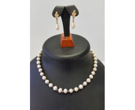 A freshwater pearl necklace together with a pair of Trifari faux pearl earrings. Necklace has 925 clasp, earrings drop style.