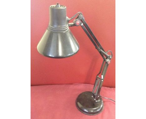 A modern black angle poise lamp  