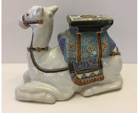 Large ceramic camel plant stand. Initialled to the base, possibly AM. Measures 15" wide x 12" tall.