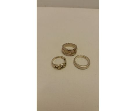 3 silver rings. One with Mother of Pearl inlay, a plain band and one with knot design. Different ring sizes.