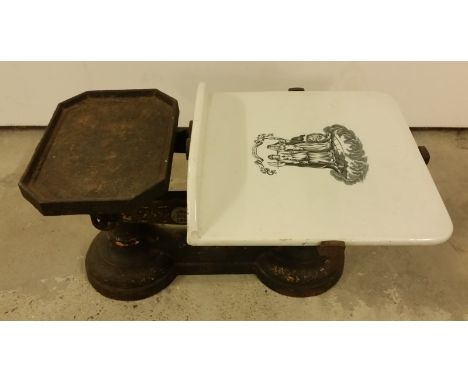 A pair of cast iron scales with ceramic weighing platform. Marked ER 386 LCC 