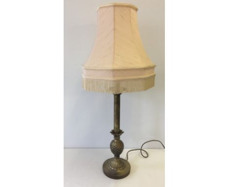 A brass effect table lamp with pineapple decoration and peach coloured shade.  65cm tall including shade.