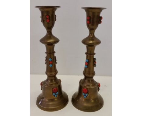 A pair of brass candlesticks. Set with blue & orange ceramic cabouchons. 