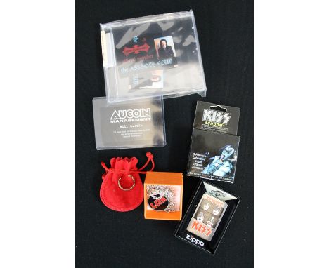 KISS - a collection of Kiss related memorabilia to include an early Aucoin business card, a gold plated ring, a Zippo Dynasty