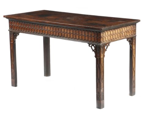 A George III mahogany serving or side table in Chippendale style, the rectangular top above a Gothic blind-fret carved frieze