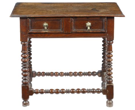 A William and Mary oak side table, the top with a moulded edge, above a frieze drawer with a panelled front, on bobbin turned