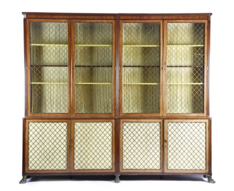 A Regency mahogany bookcase, with ebonised edging, the reeded cornice with a plain frieze, above four glazed doors with later