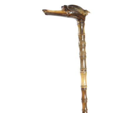 λ&nbsp;A late Victorian sectional horn walking cane, the handle carved with a greyhound head, together with a similar walking