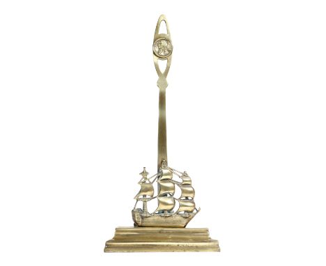 A Victorian brass 'Nelson' doorstop, in the form of H.M.S. Victory, the pierced handle with a portrait bust medallion titled 