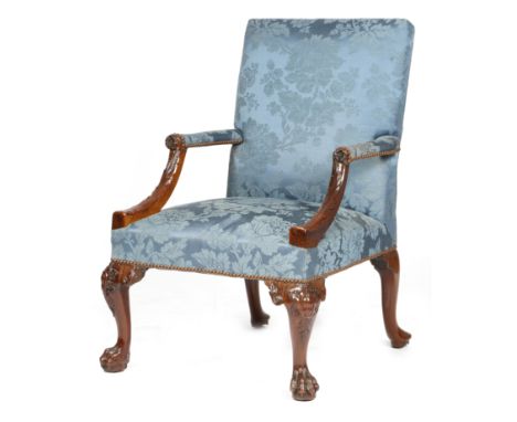 A George II red walnut library armchair, the padded back, armrests and seat covered in blue silk damask fabric, the down-turn