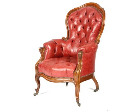 A mid-19th century walnut armchair, later button upholstered with studded red leather, with a moulded showframe, with a serpe