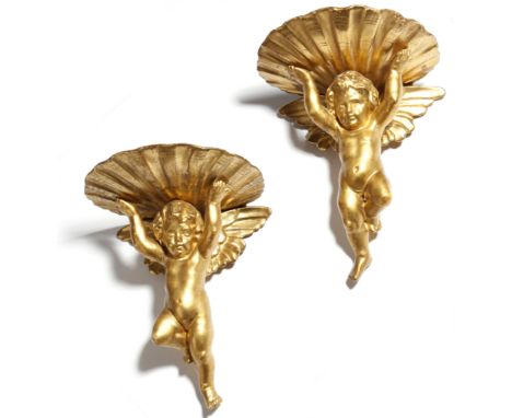 A pair of 19th century Italian giltwood wall brackets in Baroque style, each in the form of a winged cherub supporting a shel