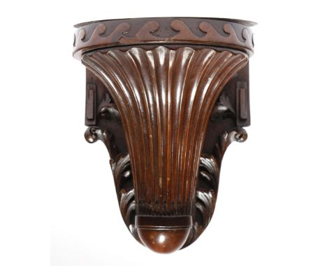 A mahogany wall bracket in 18th century style, the dished top above a Vitruvian scroll and a fan moulded support, 22.5cm high
