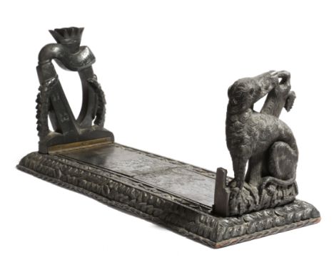 A Victorian Irish bog oak bookslide in the manner of Cornelius Goggin, the hinged folding ends carved with a wolf hound, a ha