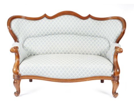 A Victorian mahogany two seater sofa, with a moulded showframe and a serpentine wing back, on cabriole front legs and scroll 