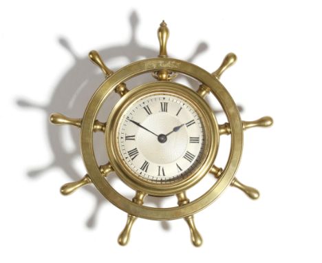 A novelty brass ship's wheel wall clock, with a lever escapement, the silvered dial with Roman numerals and an engine turned 