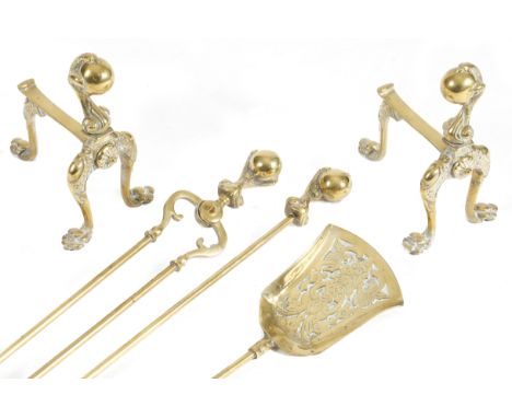 A set of three late Victorian brass fire tools, each with a claw and ball handle, the pan decorated with leaves, flowers and 