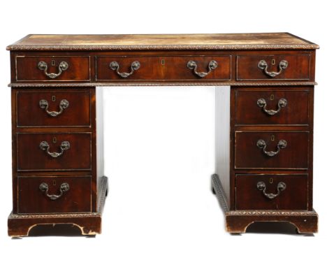 A mahogany twin pedestal desk in Chippendale style by Spillman, the top inset with a tooled leather writing surface within a 
