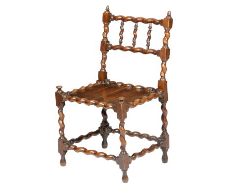 A rare Charles II yew wood 'spindle back' chair, with turned acorn finials, above a triple barley twist spindle back, with a 