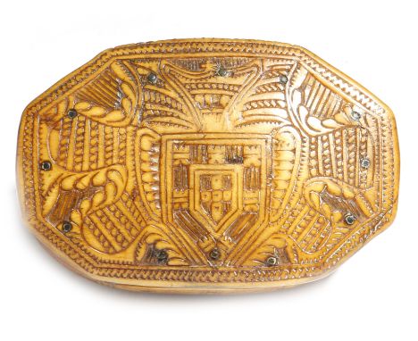 An 18th century horn snuff box, the hinged lid relief carved with a cartouche and the coat of arms of the Kingdom of Portugal