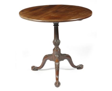 A George II mahogany tripod table, the circular tilt-top on a fluted urn turned stem, on leaf and cartouche capped cabriole l