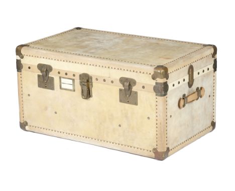 A French studded vellum trunk, with brass mounts, the interior with two lift-out trays, early to mid-20th century, 47.6cm hig