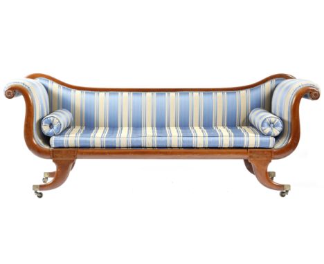 A late Regency mahogany scroll end sofa, with a detachable back, later covered with blue striped fabric, with a squab cushion