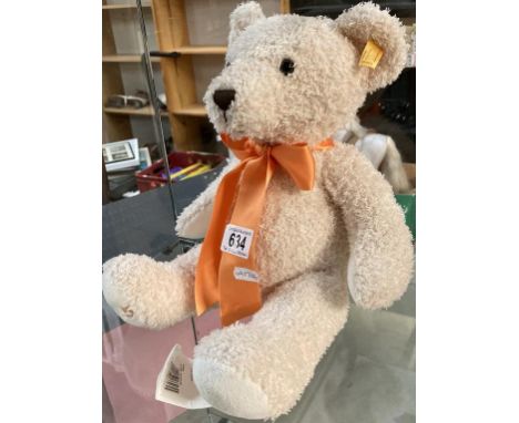 A Steiff bear with orange ribbon