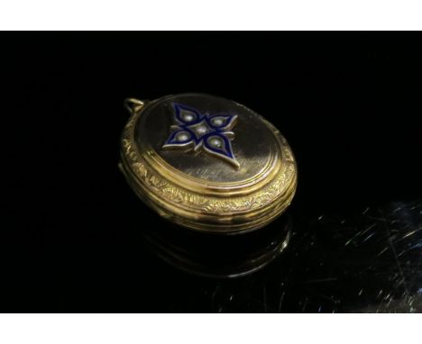 A Victorian rose gold plated front and back locket with enamel and seed pearl decoration to front