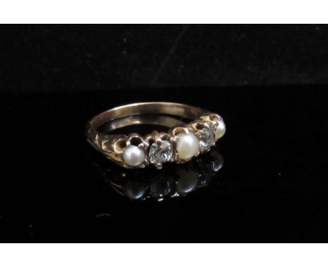 A gold five stone pearl and diamond ring, three pearls and two old cut diamonds, stamped 15ct. Size P, 3.2g