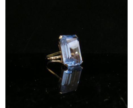 A gold dress ring with large blue stone. Shank stamped 18ct. Size Q, 11g