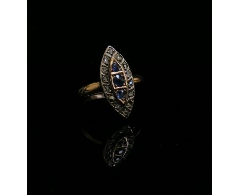 A gold lozenge shaped ring, three sapphires in vertical setting framed by old cut diamonds, stamped 9ct. Size K, 2g