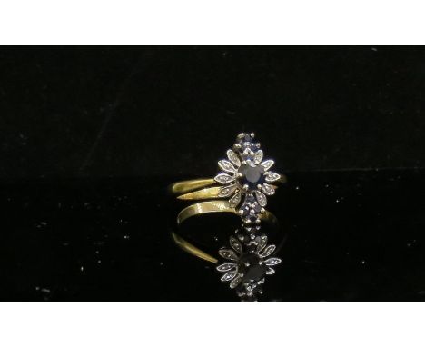 A sapphire and diamond cluster ring stamped 18ct. Size L/M, 4.3g
