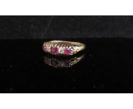 An 18ct gold diamond and ruby five stone ring. Size Q, marks rubbed, 2.7g