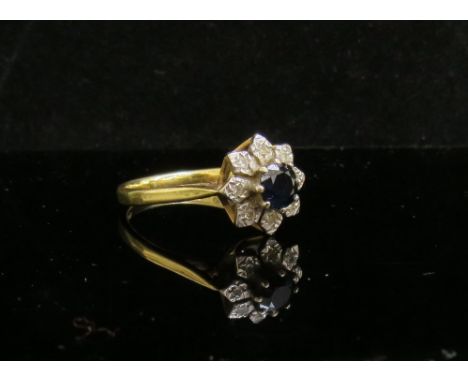 An 18ct gold sapphire and diamond cluster ring. Size P/Q, 3.9g