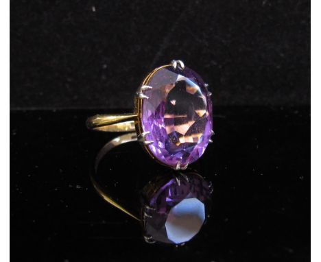 A gold ring set with oval amethyst, marks rubbed. Size N, 5.1g