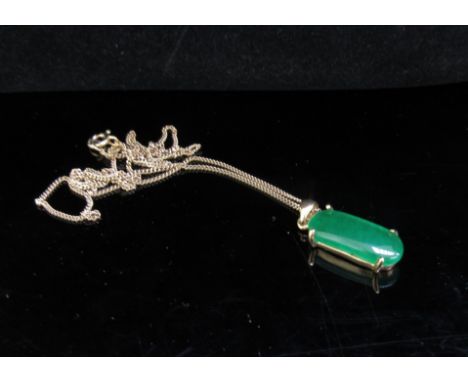 A 9ct gold chain hung with a cabochon jade pendant stamped 18k, 52cm long, 4.5g